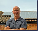 Tim Morgan in front of The Publicity Works' solar panels